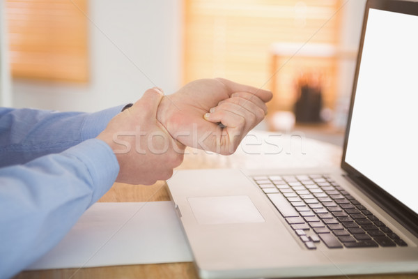 Businessman clutching his painful wrist Stock photo © wavebreak_media