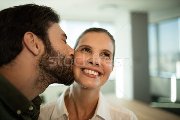 Empresário beijando empresária escritório laptop Foto stock © wavebreak_media