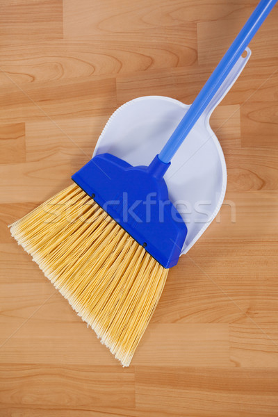 Sweeping broom with dustpan on wooden floor Stock photo © wavebreak_media