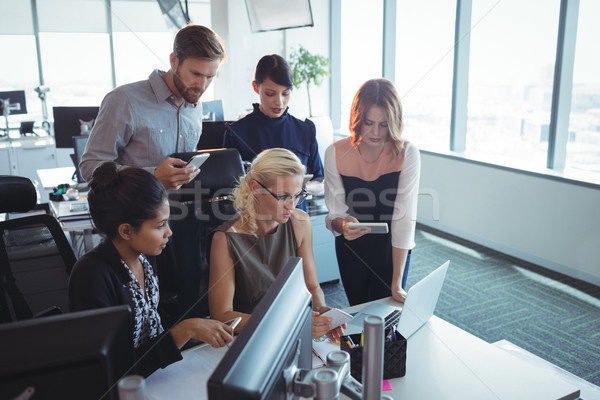 Focused business colleagues working together while using technologies Stock photo © wavebreak_media