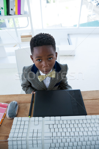 Vue garçon affaires séance bureau [[stock_photo]] © wavebreak_media