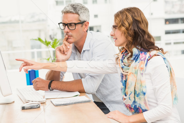 Stock photo: Two casual designers working with computer