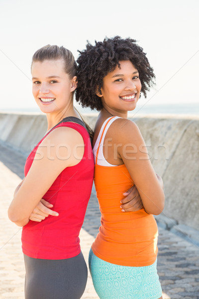 Deux souriant jeunes femmes permanent Retour portrait [[stock_photo]] © wavebreak_media