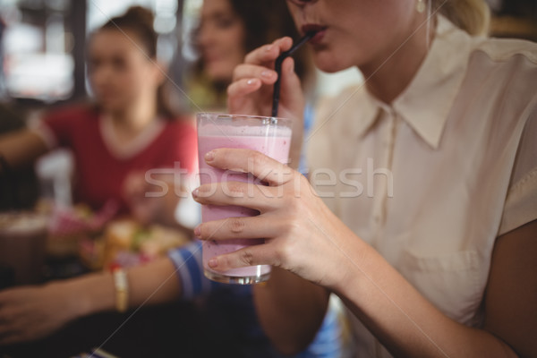 Midsection of woman drinking milkshake at cafe Stock photo © wavebreak_media