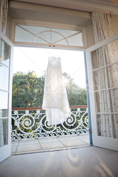 Wedding dress hanging at doorway Stock photo © wavebreak_media