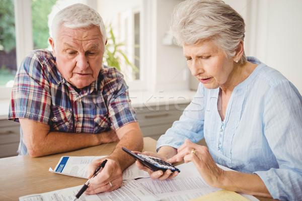 Worried senior couple checking their bills Stock photo © wavebreak_media
