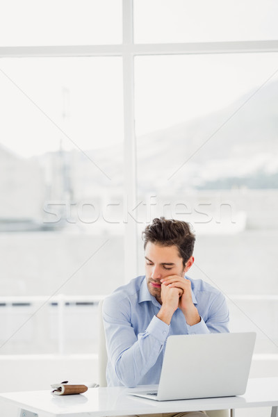 Tensed businessman sitting at table with laptop Stock photo © wavebreak_media