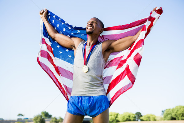Foto stock: Atleta · posando · bandeira · americana · ouro · em · torno · de