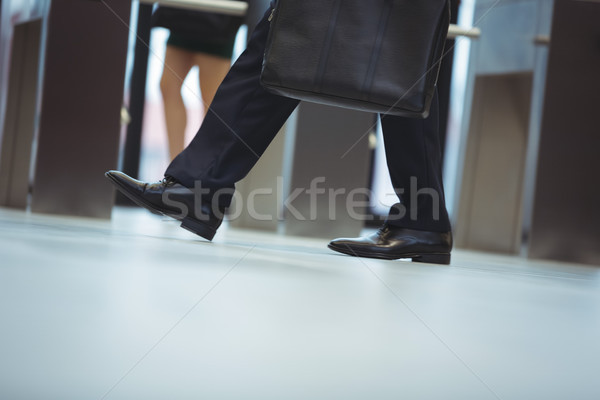 Businessman with briefcase walking in the office Stock photo © wavebreak_media