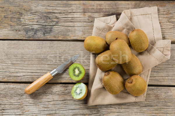 Kiwis with knife on wooden table Stock photo © wavebreak_media