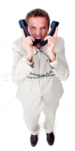 Angry businessman yelling and tangled up in phone wires  Stock photo © wavebreak_media
