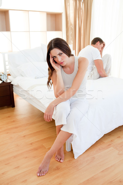 Angry couple sitting separately on their bed  Stock photo © wavebreak_media
