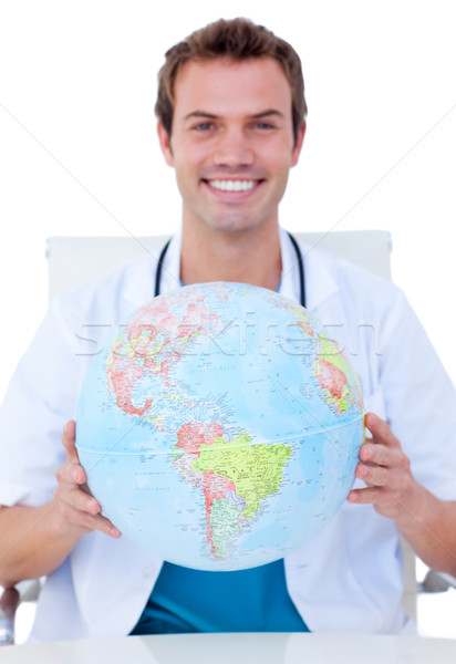 Portrait of a smiling male doctor holding a terrestrial globe Stock photo © wavebreak_media