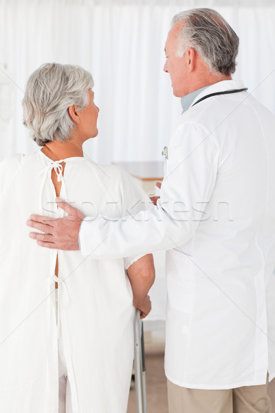 Doctor helping his patient to walk Stock photo © wavebreak_media