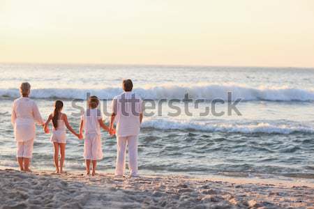 Stockfoto: Mooie · familie · strand · zonsondergang · zee · oceaan