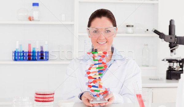 Beautiful scientist showing the dna double helix model Stock photo © wavebreak_media