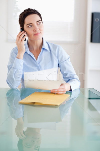 Businesswoman with papers on the phone in an office Stock photo © wavebreak_media