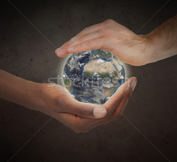 Two hands protecting a glowing planet globe against a white background Stock photo © wavebreak_media