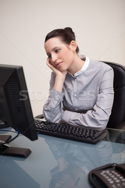 Stock photo: Young businesswoman waiting patiently for her pc to work