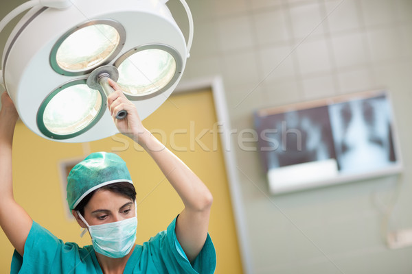 Woman holding a surgical light in a surgical room Stock photo © wavebreak_media