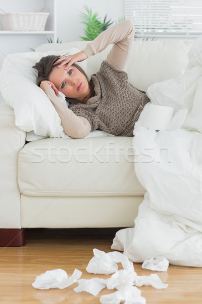 Stock photo: Upset and sick women lying on the sofa in the living room