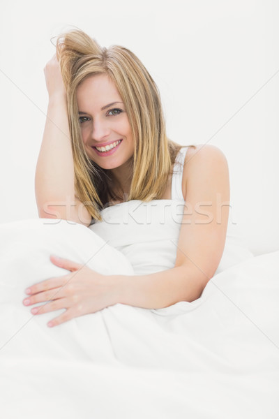 Portrait of beautiful woman sitting in bed Stock photo © wavebreak_media
