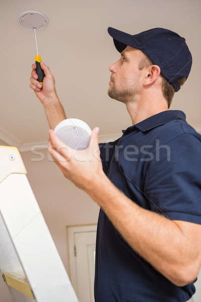 Handyman installing smoke detector Stock photo © wavebreak_media