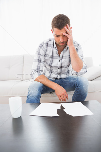 A troubled man looking papers Stock photo © wavebreak_media