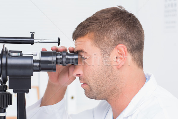 Stock photo: Optician using slit lamp in clinic