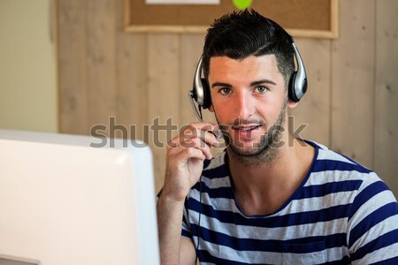 Businessman using headset in warehouse Stock photo © wavebreak_media