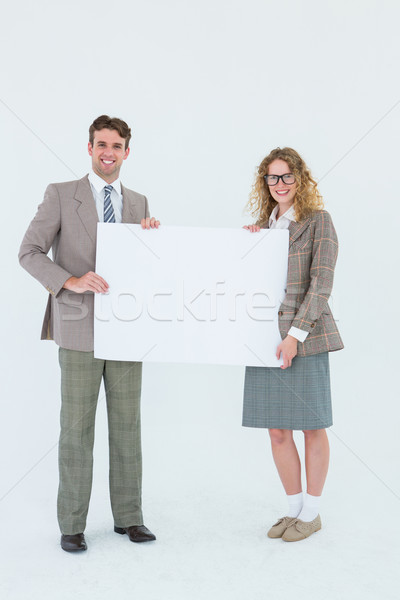 Hipster couple holding poster smiling at camera Stock photo © wavebreak_media