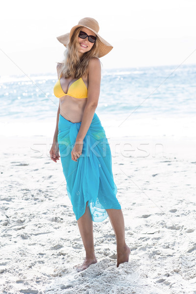 Smiling pretty blonde posing with sarong Stock photo © wavebreak_media