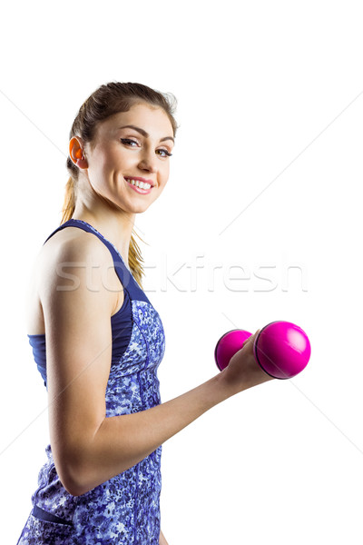 Fit woman lifting pink dumbbell Stock photo © wavebreak_media