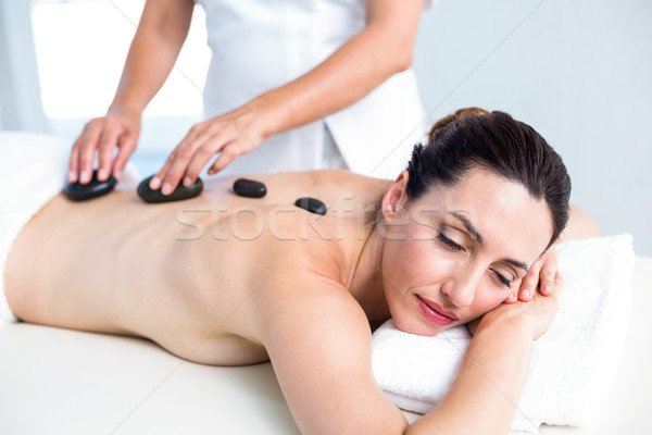 Souriant brunette chaud pierre massage saine Photo stock © wavebreak_media