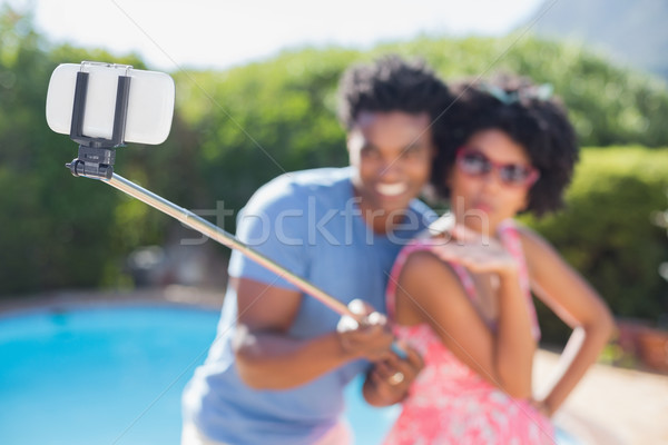 Happy couple using a selfie stick Stock photo © wavebreak_media