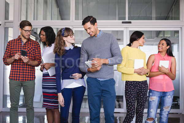 Business people with tablet computers standing in corridor Stock photo © wavebreak_media
