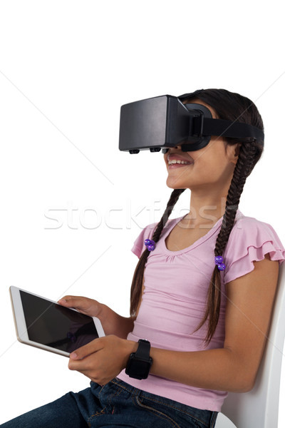 Girl using virtual reality headset and digital tablet Stock photo © wavebreak_media