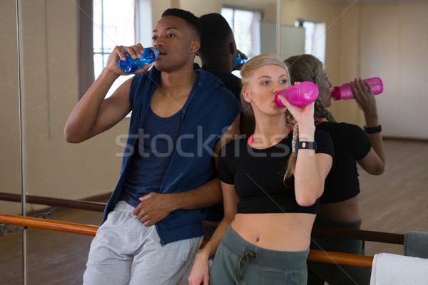 Tired dancers drinking water in studio Stock photo © wavebreak_media