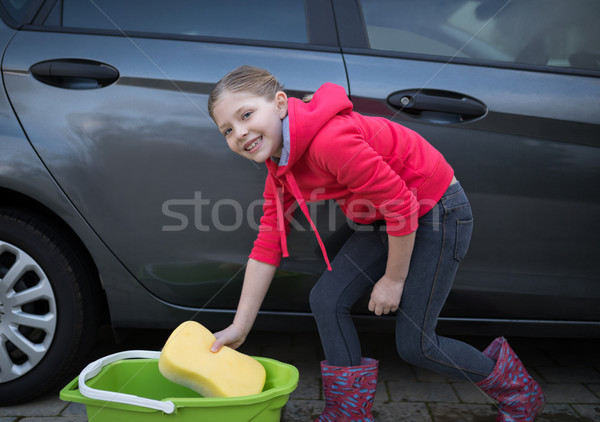 Teenage girl washing a car on a sunny day Stock photo © wavebreak_media