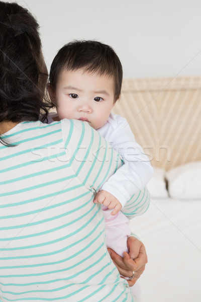 Lovely mother carrying baby daughter Stock photo © wavebreak_media