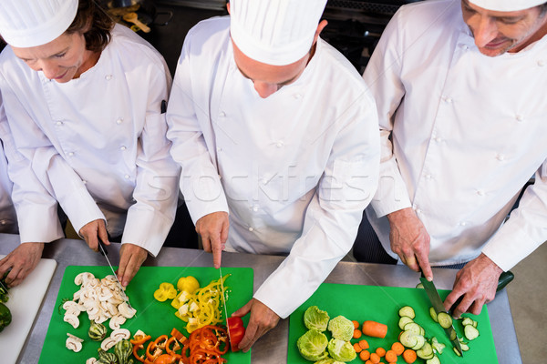 Team of chefs chopping vegetables  Stock photo © wavebreak_media