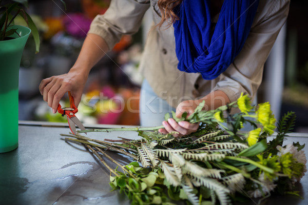 Female florist trimming flower stem Stock photo © wavebreak_media