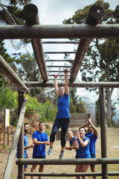 Fit woman climbing monkey bars Stock photo © wavebreak_media