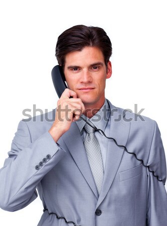 Serious male executive tangle up in phone wires  Stock photo © wavebreak_media