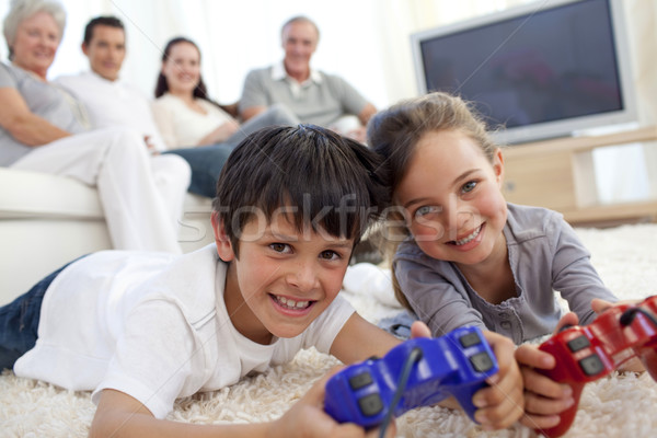 Children playing video games and family on sofa Stock photo © wavebreak_media