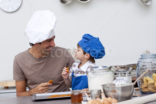 Smiling father and son eating home-made cookies Stock photo © wavebreak_media