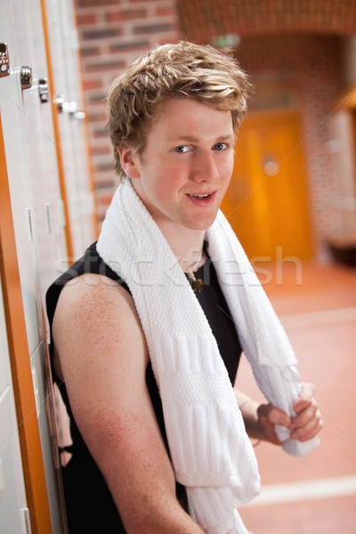 Portrait of a sports student leaning on a locker with a towel Stock photo © wavebreak_media