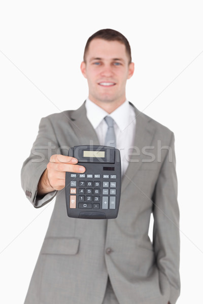 Portrait of a businessman showing a calculator against a white background Stock photo © wavebreak_media