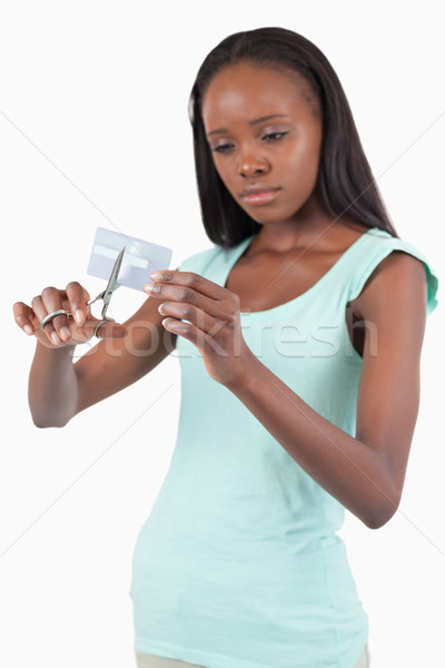 Sad looking female destroying her credit card against a white background Stock photo © wavebreak_media