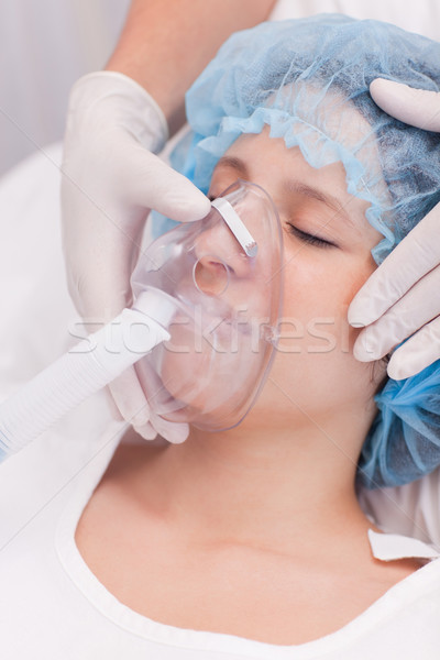 Stock photo: Young female patient with oxygen mask